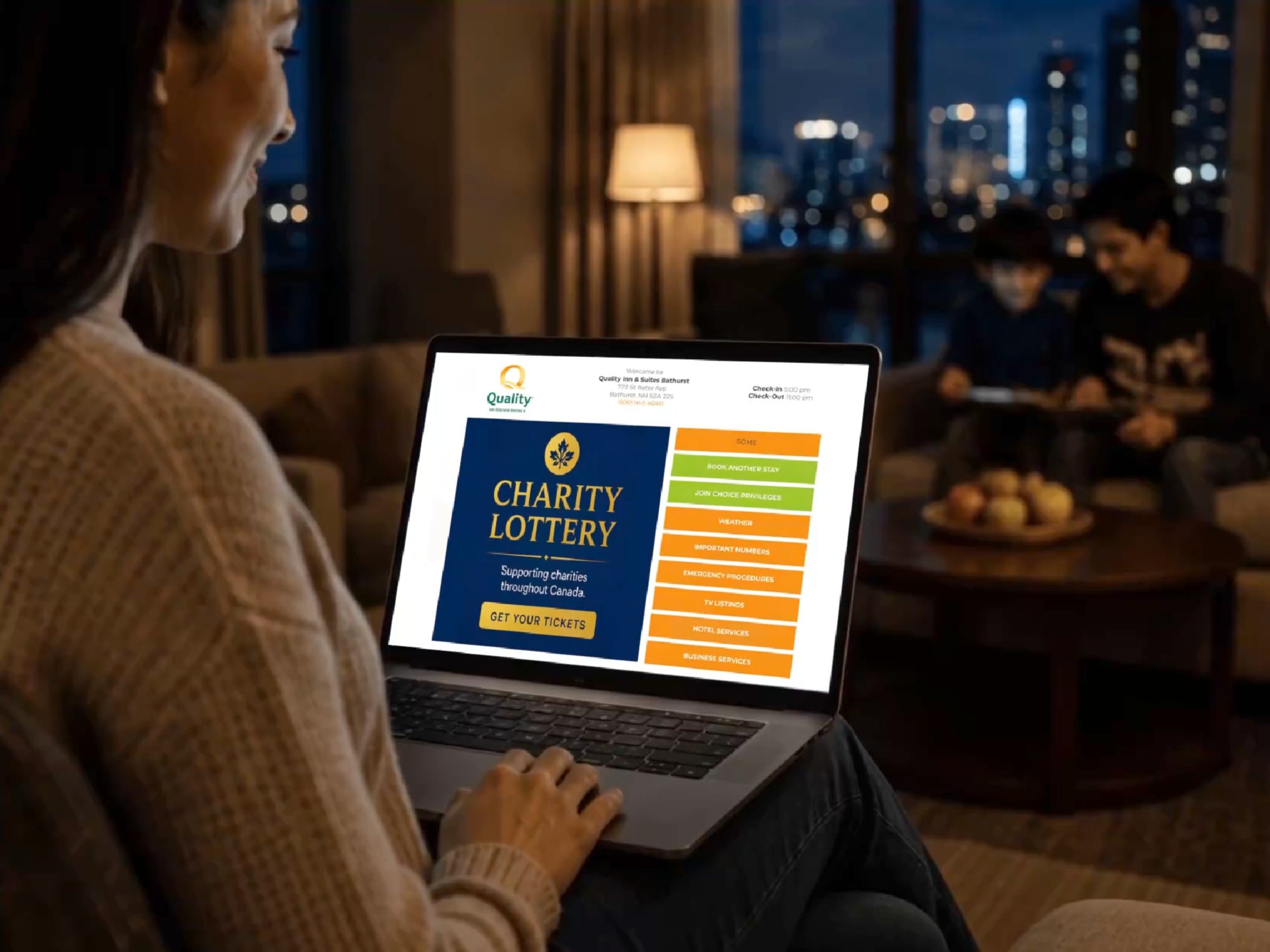 Hotel guest viewing branded welcome screen on laptop in suite.